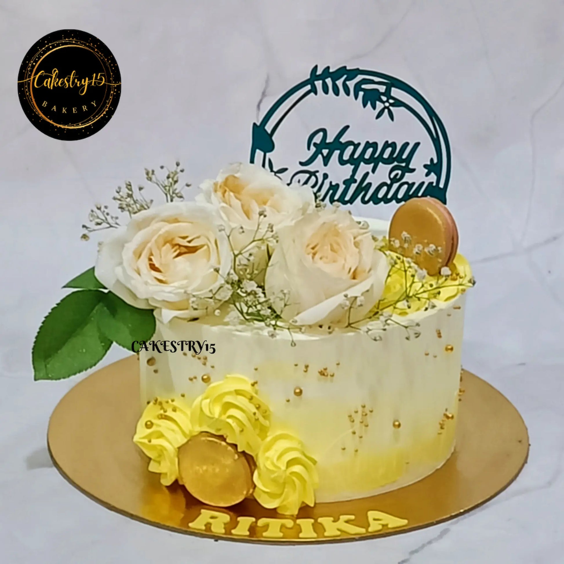 1kg floral pineapple cake by Cakestry15 topped with ivory roses, baby breath, fondant macarons, and yellow rosettes