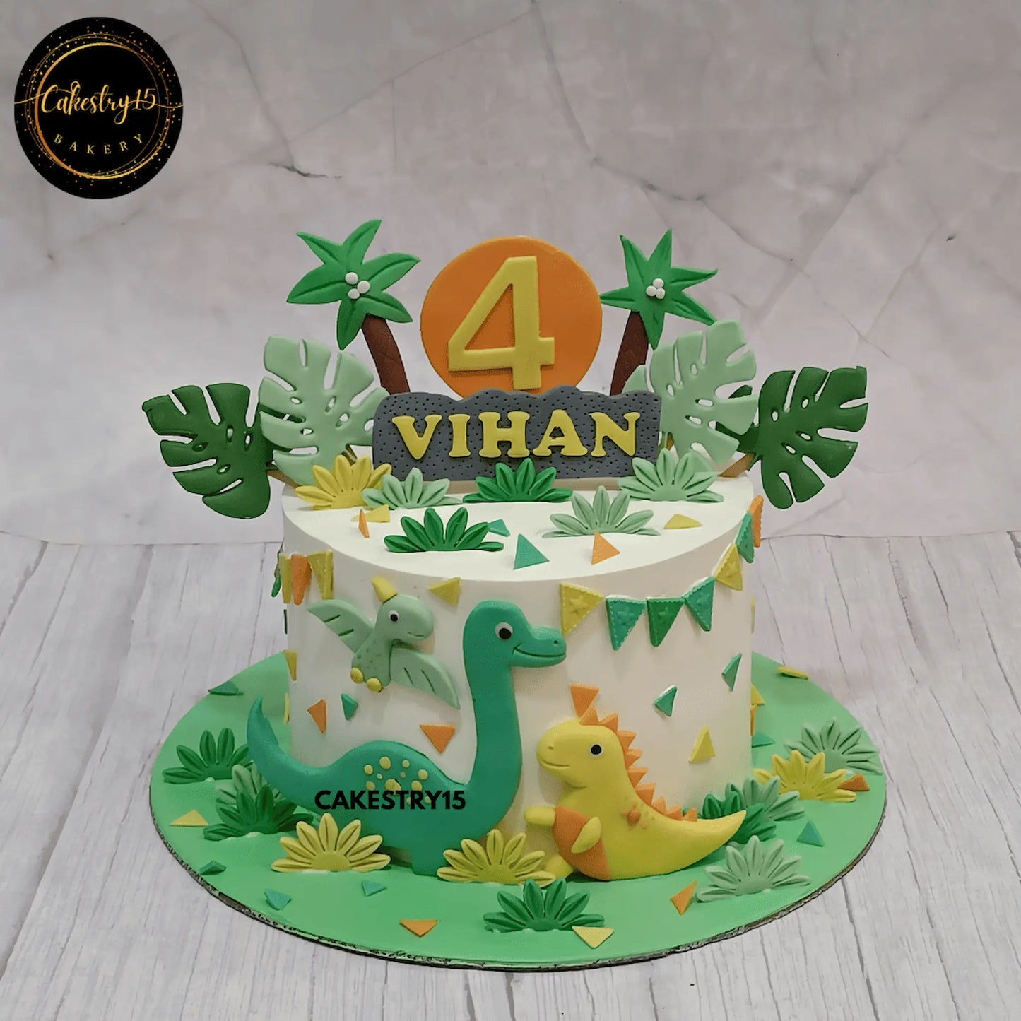 Pineapple flavor dinosaur birthday cake with fondant dinosaurs and palm trees by cakestry15 noida