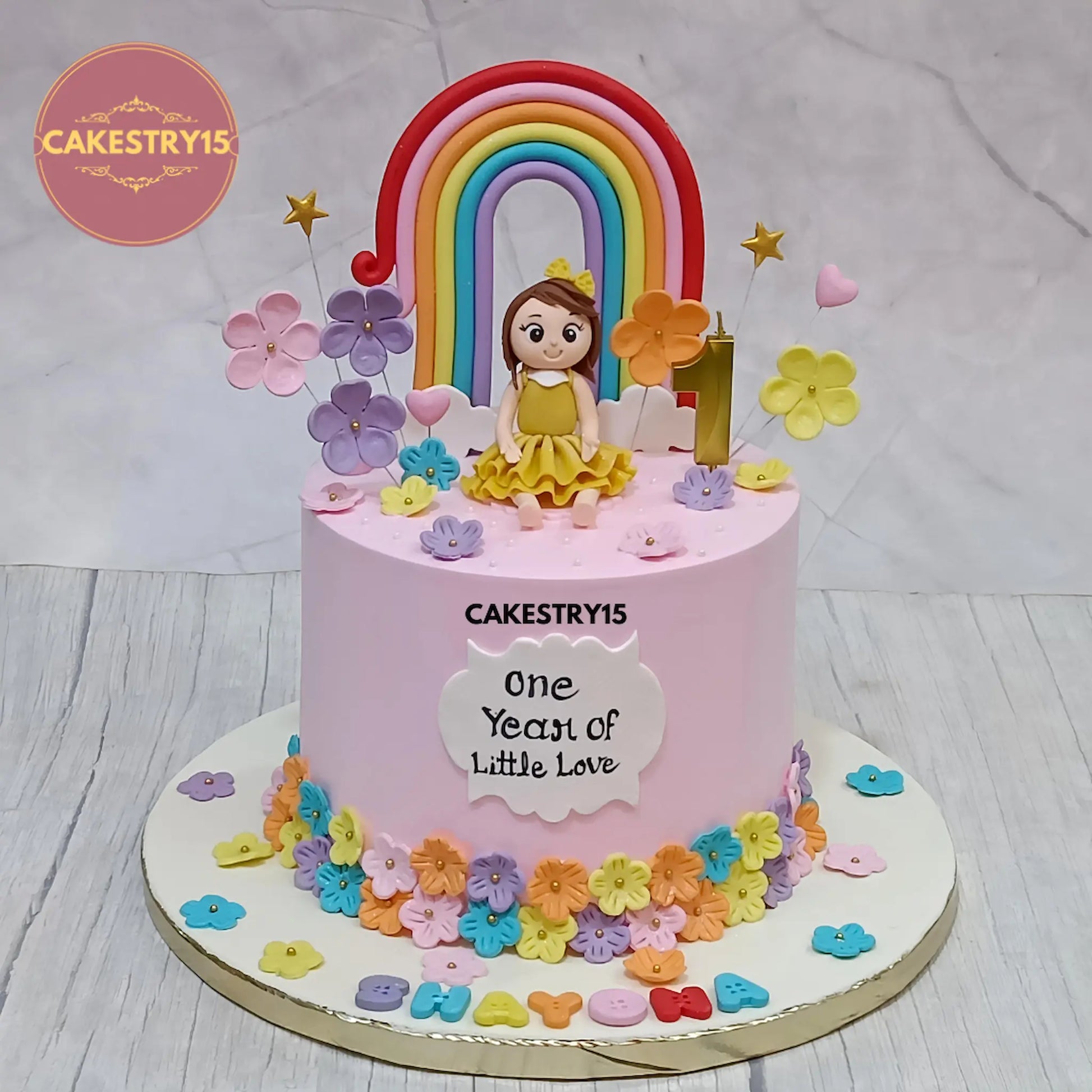 1.5kg pineapple eggless first birthday cake with girl figurine, rainbow, and fondant flowers from Cakestry15 in Noida