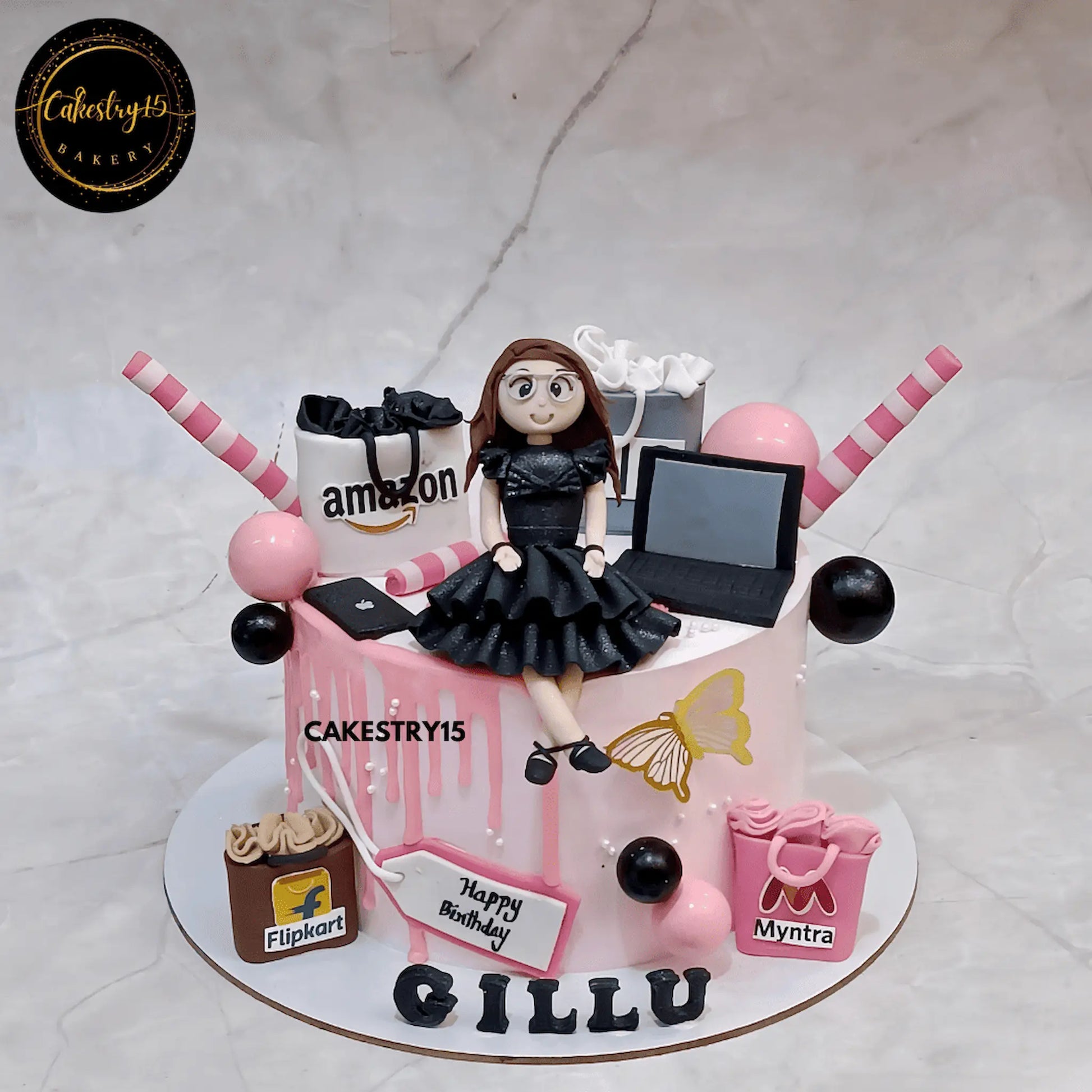 Shopaholic birthday theme cake for Gillu with girl figurine, shopping bags, and chocolate flavor by cakestry15,best bakery noida