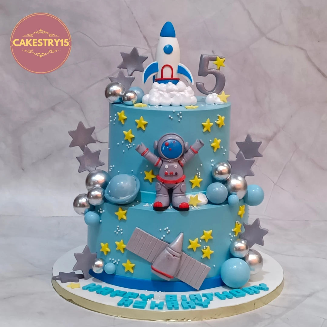 Space Astronaut kids birthday cake handcrafted with fondant astronaut, rockets and satellite as a premium theme cake Noida using fresh eggless cakes.