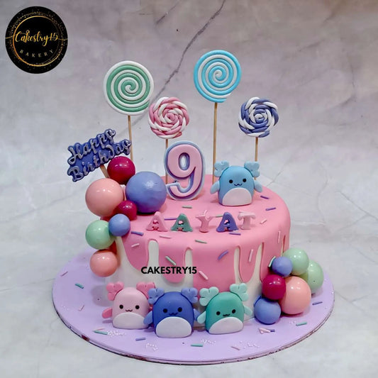 Squishmallow theme birthday cake for 9-year-old Aayat with chocolate flavor, fondant squishmallow figures, candy swirls, and birthday tag by cakestry15,best bakery noida