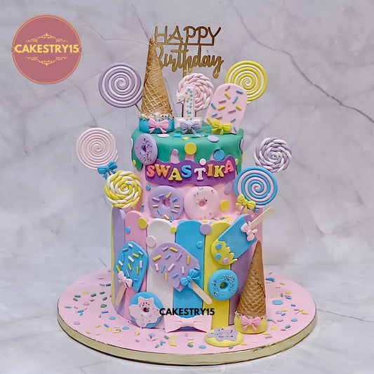 5kg eggless chocolate Candyland theme cake for Swastika’s 1st birthday with donuts, ice creams, candy swirls and fondant details by cakestry15 in noida