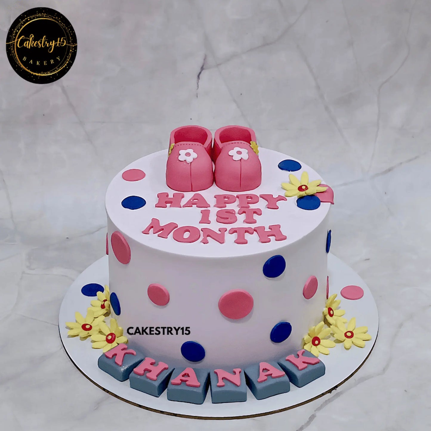 Butterscotch baby cake with shoes, polka dots and sunflowers by cakestry15 noida