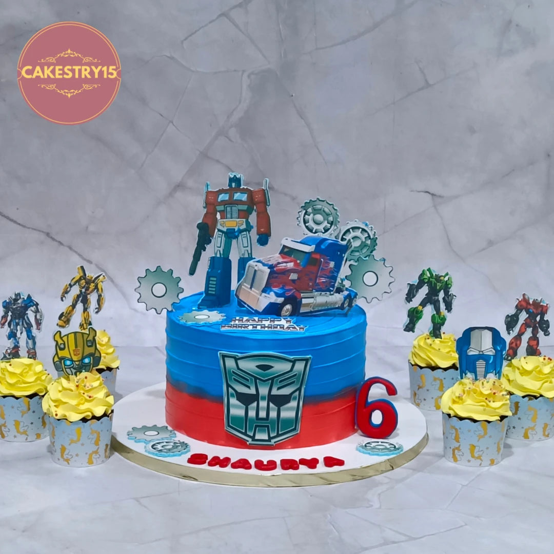 Eggless Transformers theme cake with six matching cupcakes displayed for a kids birthday cake setup in Noida.