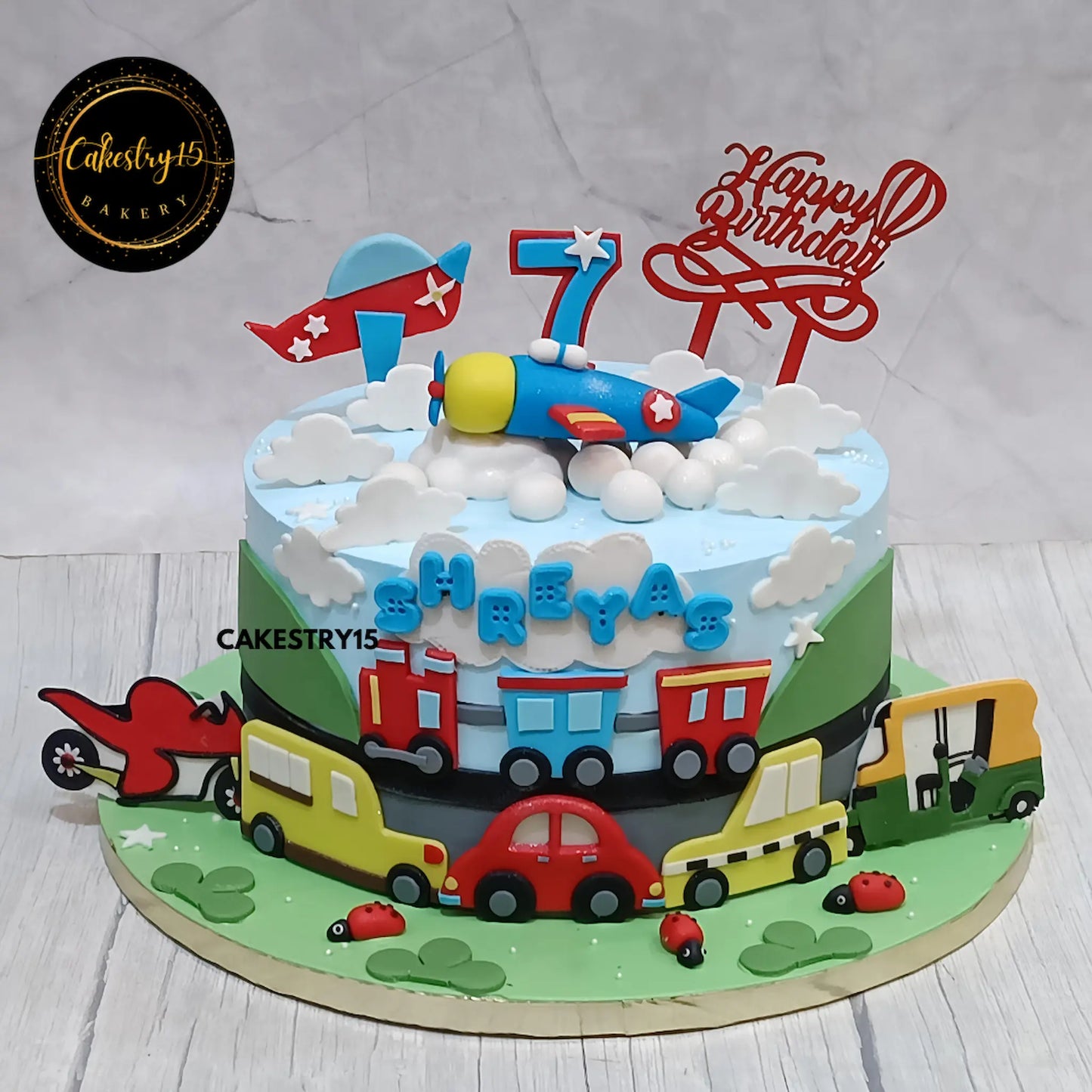 Eggless transport theme kids birthday cake with gliders and vehicles by Cakestry15 Noida