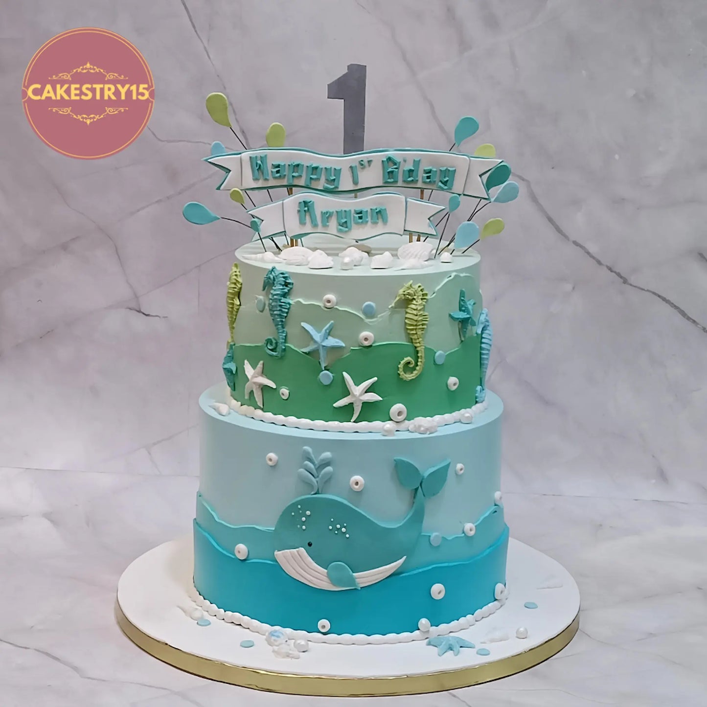 Under sea theme first birthday cake with whale, seahorse and starfish in aquatic colours, eggless custom kids birthday cake in Noida
