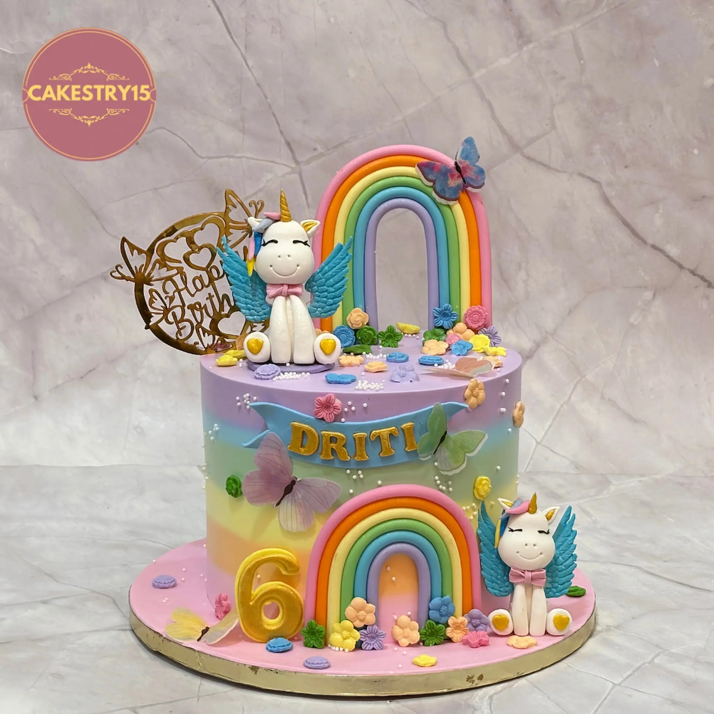 Unicorn theme magical eggless chocolate birthday cake for kids with rainbow, butterflies and custom design by Cakestry15.