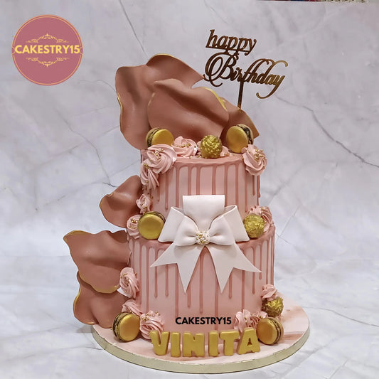 3kg eggless choco vanilla birthday cake with fondant sails, bow, Ferrero Rocher, macarons, cream rosettes, and 3D name base from Cakestry15