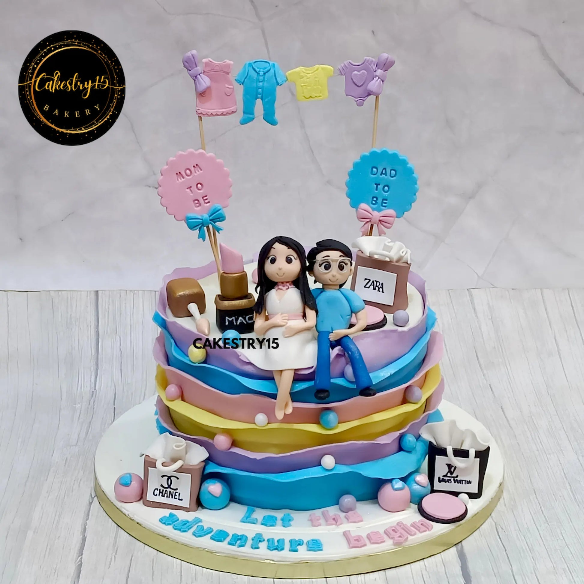 Welcome Baby 2kg chocolate cake with couple figurine, baby clothes, and fondant frills