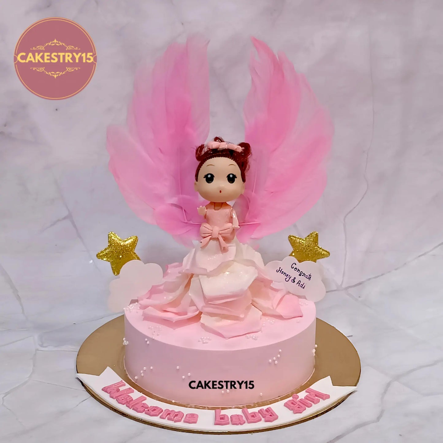 Welcome Baby Girl eggless chocolate cake with girl toy design, perfect for baby shower and newborn celebrations in Noida.