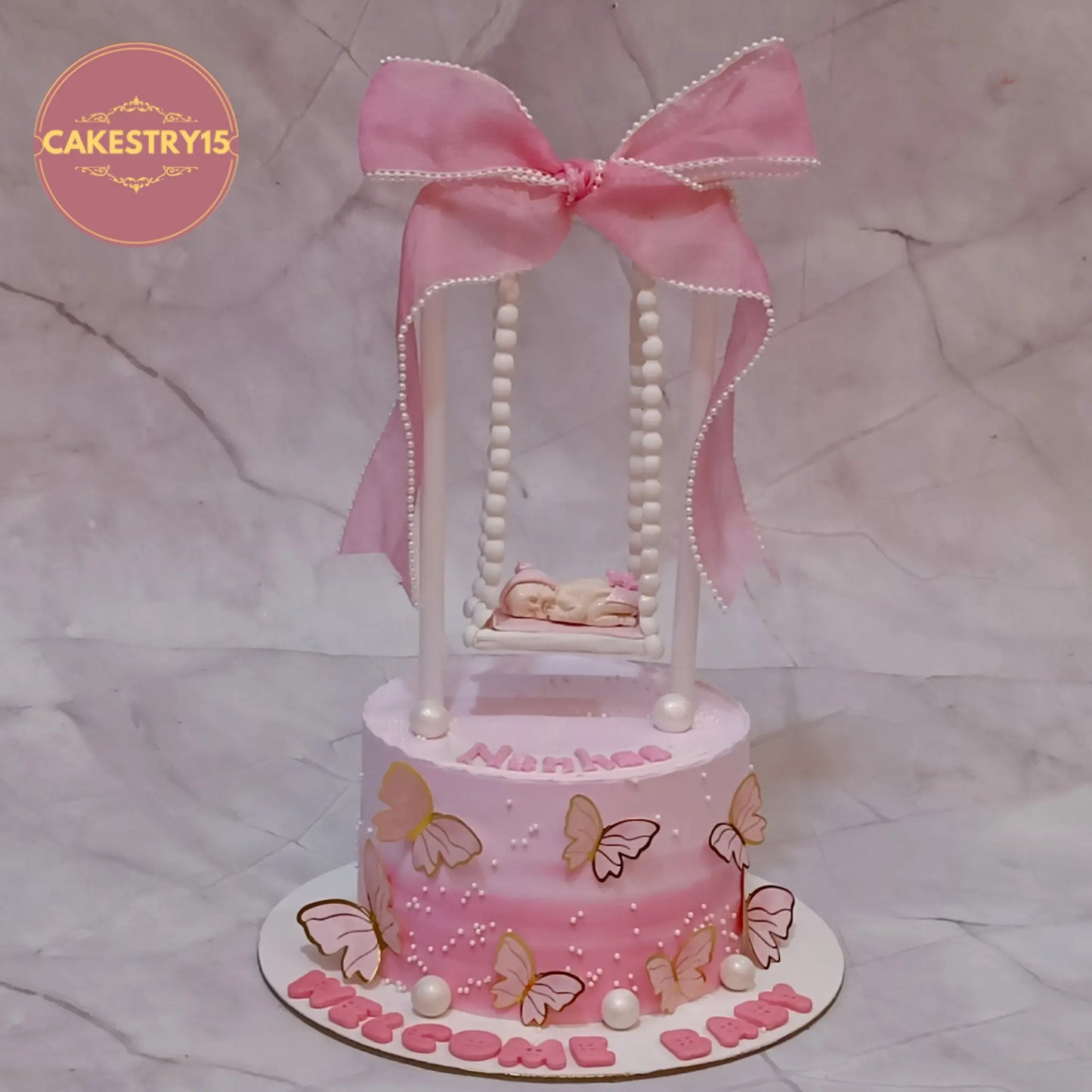 Eggless kids birthday cake with welcome baby theme cake Noida design, black forest flavour with personalised name Nanhee