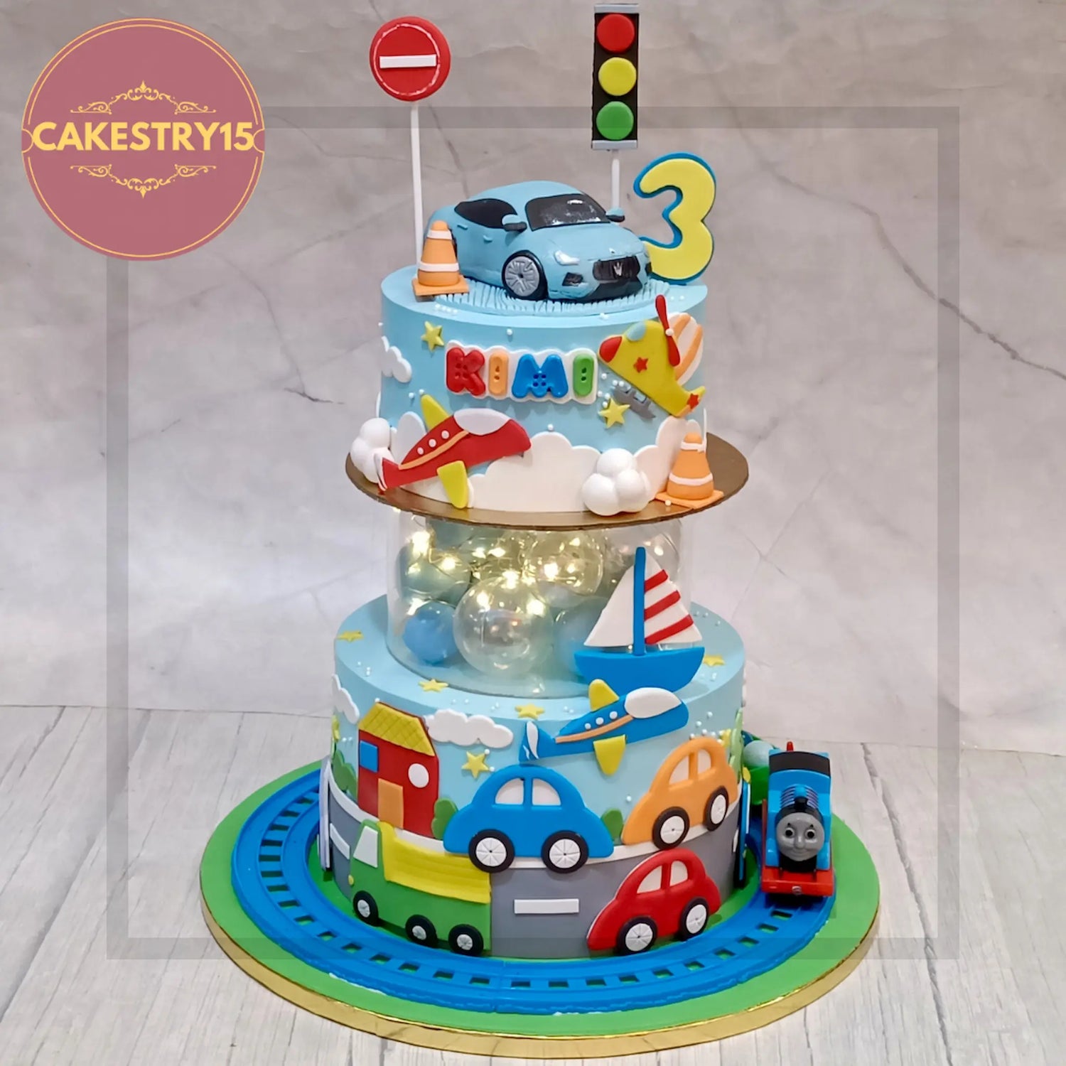 Car theme cake with toy car topper, road signs, wheels & racing track