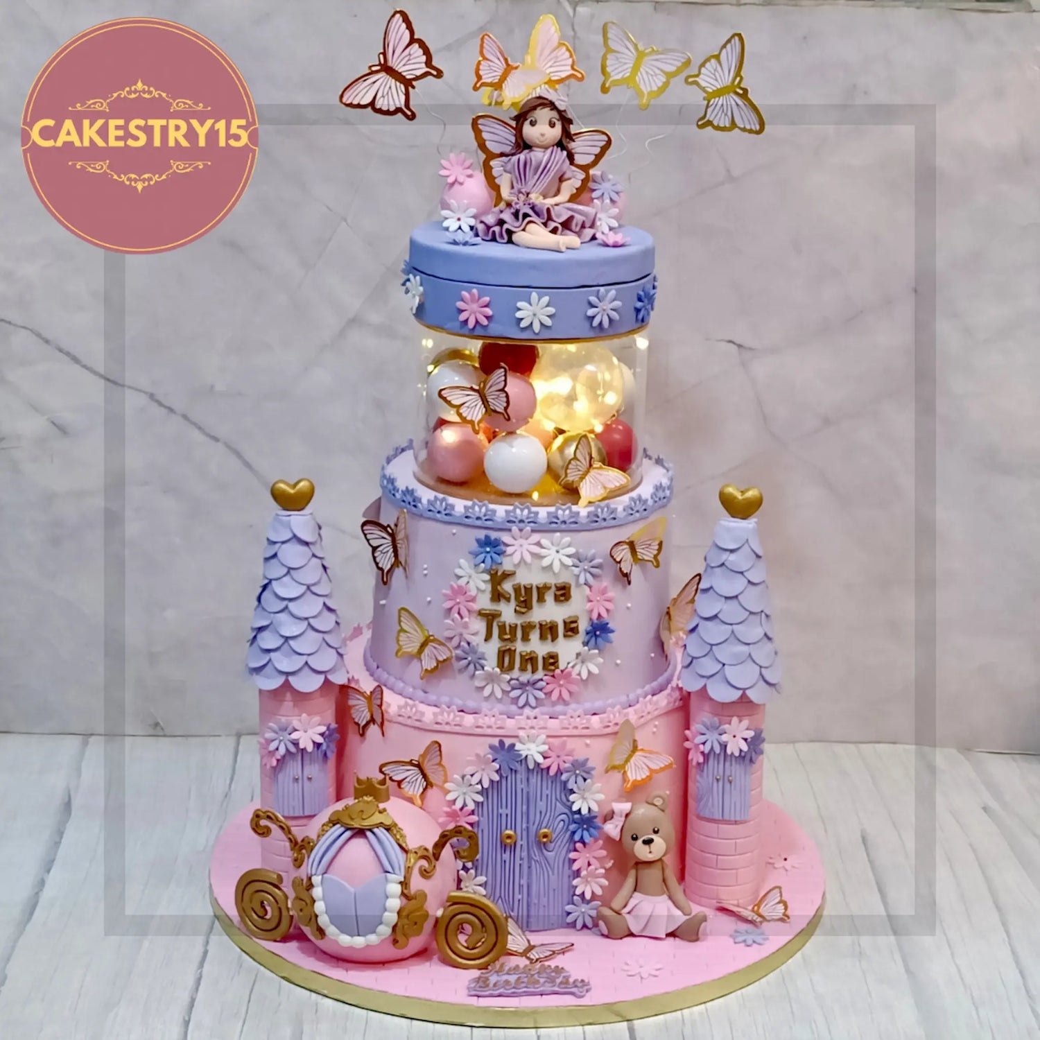 Princess Barbie theme cake with doll topper, tiara, pink frosting, and edible pearls