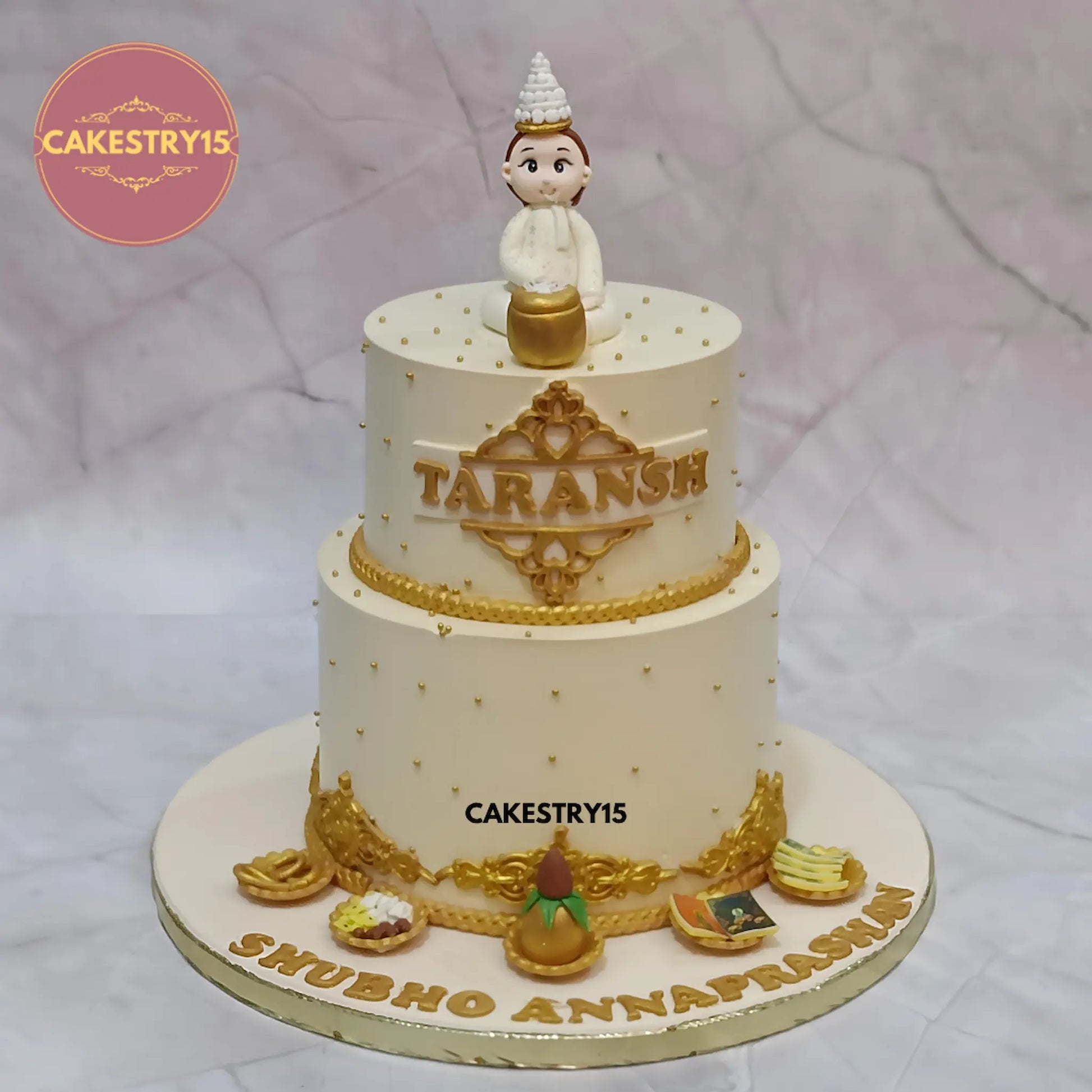 3kg choco chips Annaprashan cake with boy figurine, kalash and platters by Cakestry15 Noida.