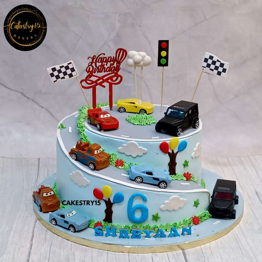 A chocolate car-themed birthday cake for a 6-year-old boy, featuring toy cars, roads, traffic signals, and fondant decorations by cakestry15 noida