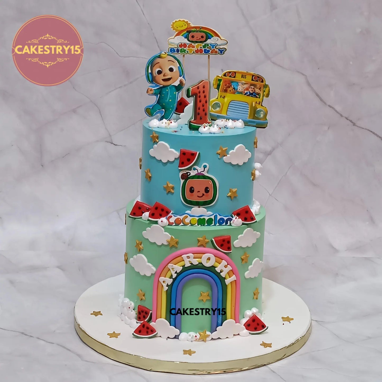 3kg eggless Cocomelon butterscotch first birthday cake from Cakestry15 Noida featuring edible Cocomelon prints and fondant rainbow