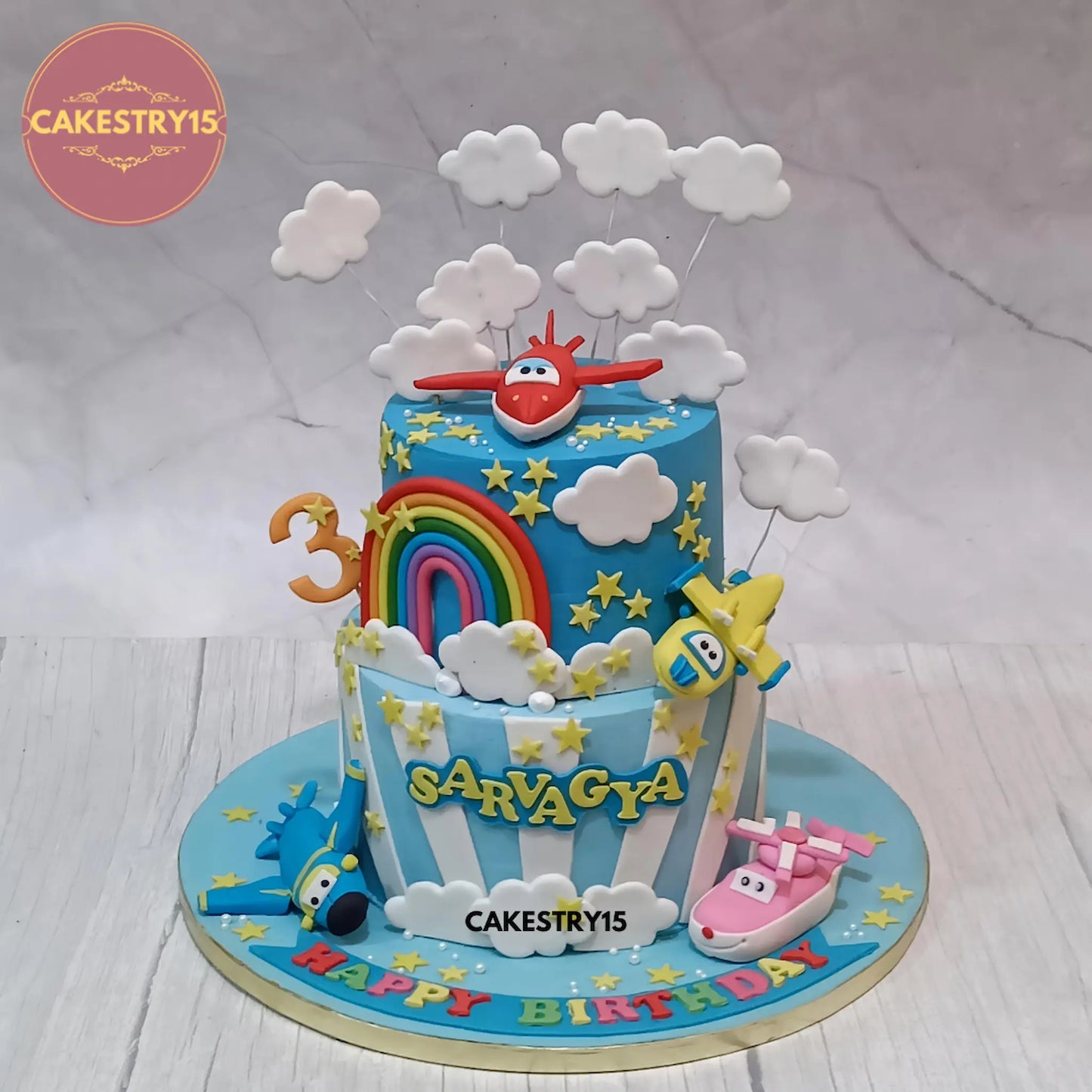 Eggless aeroplane theme birthday cake for kids with fondant clouds and rainbow design by Cakestry15 in Noida