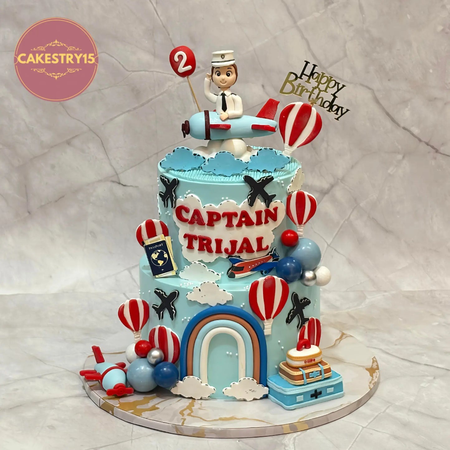 Eggless aeroplane theme kids birthday cake with boy figurine, aeroplanes, clouds and rainbow for a 2nd birthday in Noida.