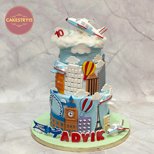 Eggless aeroplane theme rotating birthday cake with chocolate flavour, clouds, buildings, and aeroplane topper for kids birthday in Noida