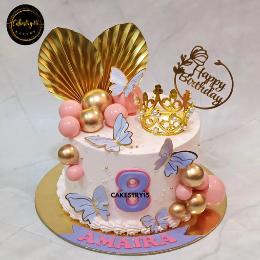Amaira’s 1kg butterscotch birthday cake with crown, paper ferns, and butterflies from Cakestry15