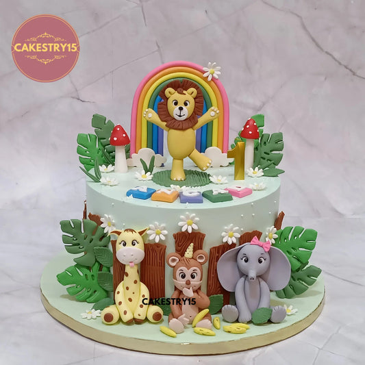 Angad’s 2kg choco vanilla jungle theme first birthday cake with fondant lion, giraffe, monkey, and elephant