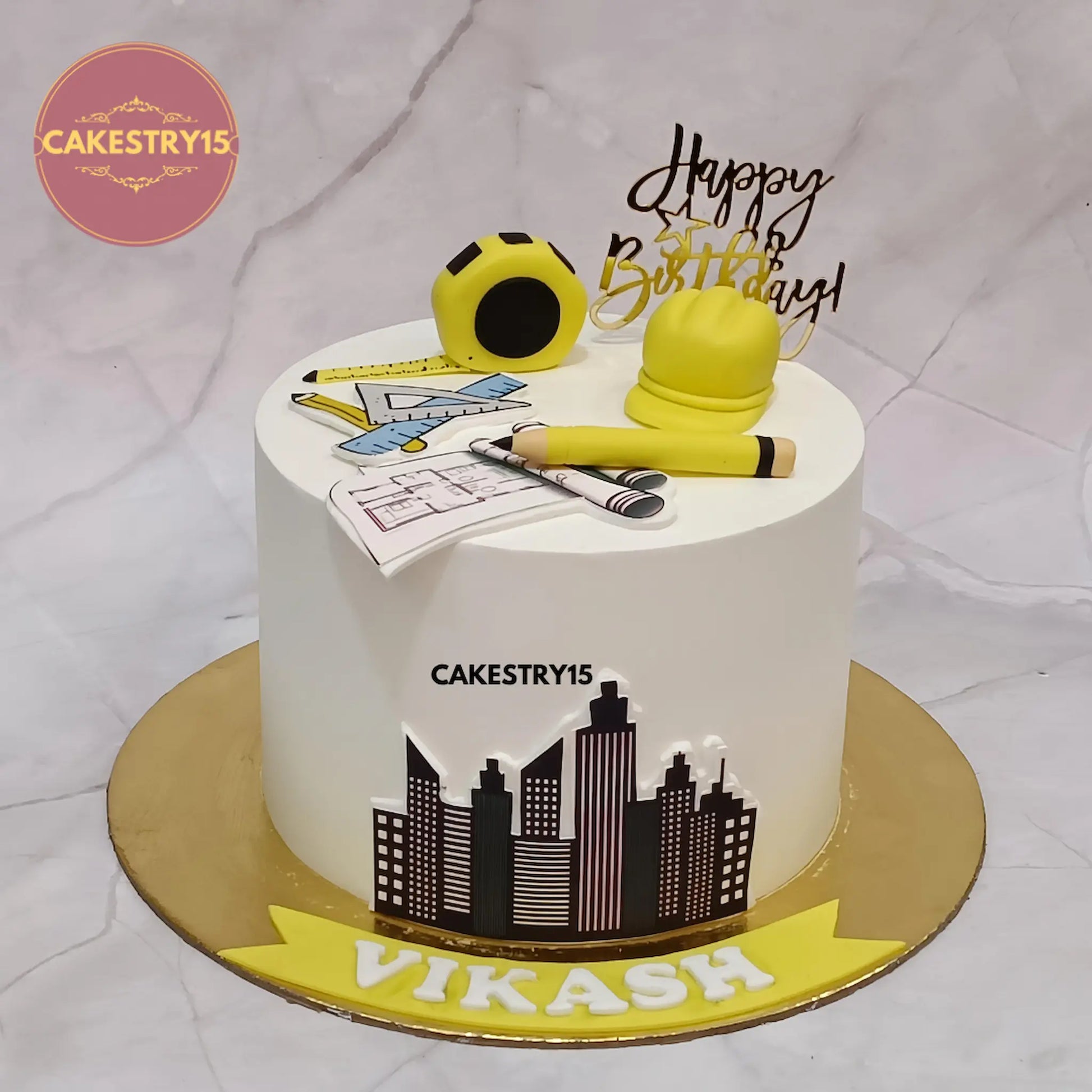 Architect theme 1kg pineapple cake with edible tools and building image from Cakestry15 Noida