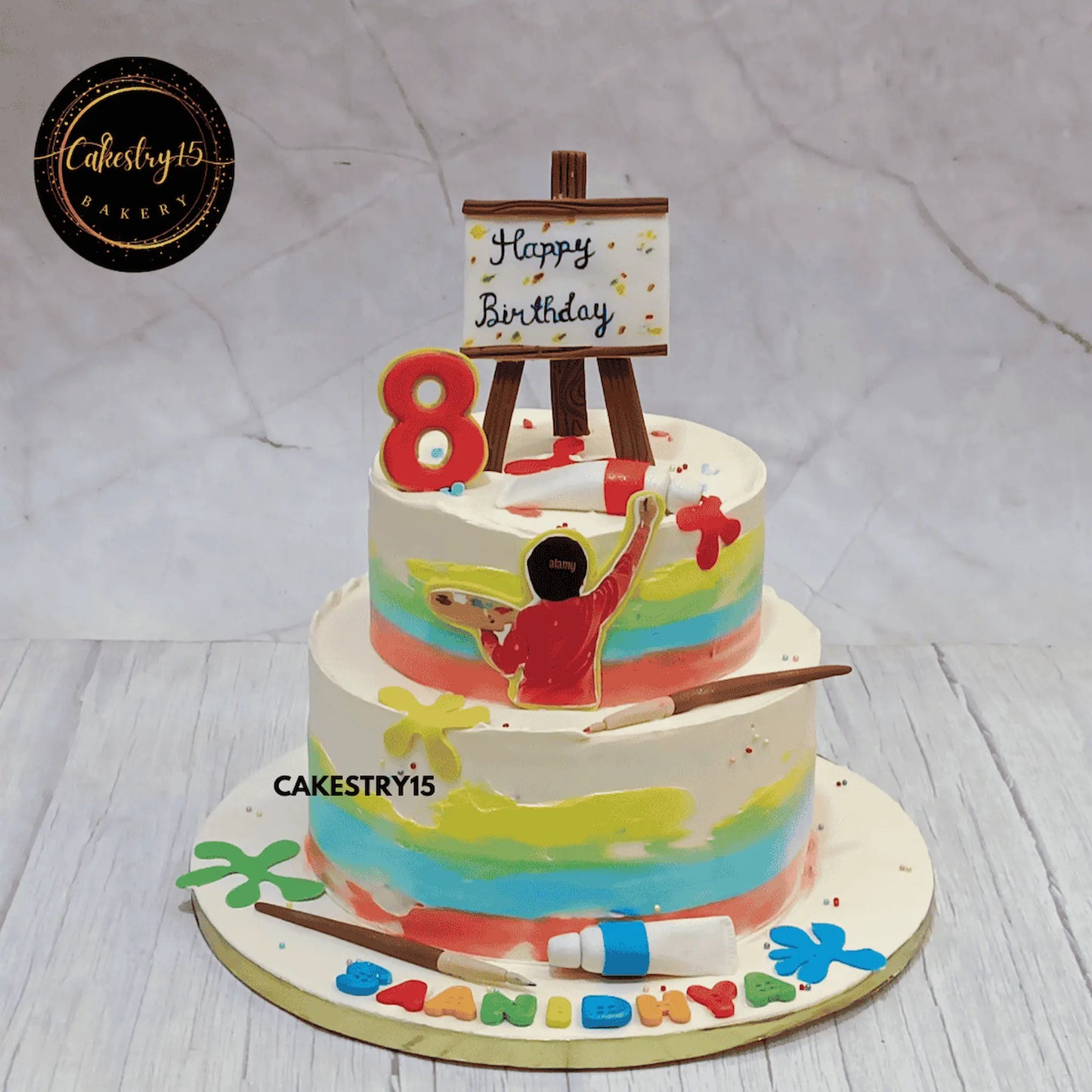 Eggless kids birthday cake with colourful art theme design and chocolate flavour, custom theme cake Noida for creative birthday celebrations.