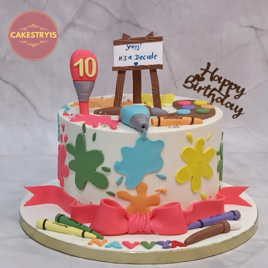 Artist theme kids birthday cake with colourful paint elements and eggless cake design in Noida for 10th birthday celebrations.