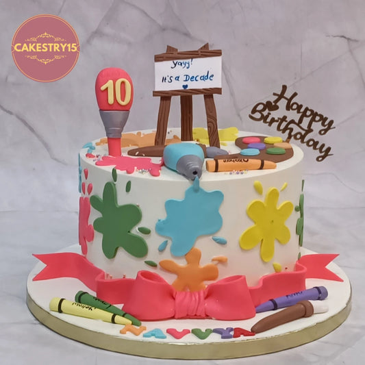 Artist theme kids birthday cake with colourful paint elements and eggless cake design in Noida for 10th birthday celebrations.