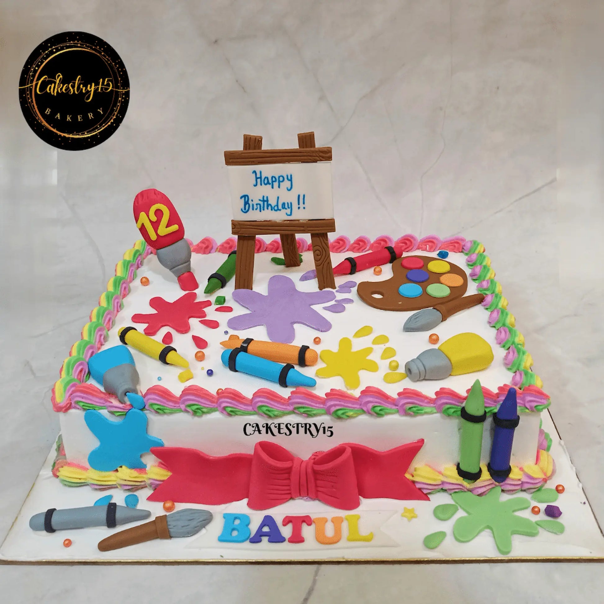 Eggless artist theme kids birthday cake in Noida with colourful fondant paint splashes and creative art design.