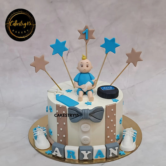 1kg eggless pineapple first birthday cake for Aryan with boy figurine, fondant decor, and custom name blocks