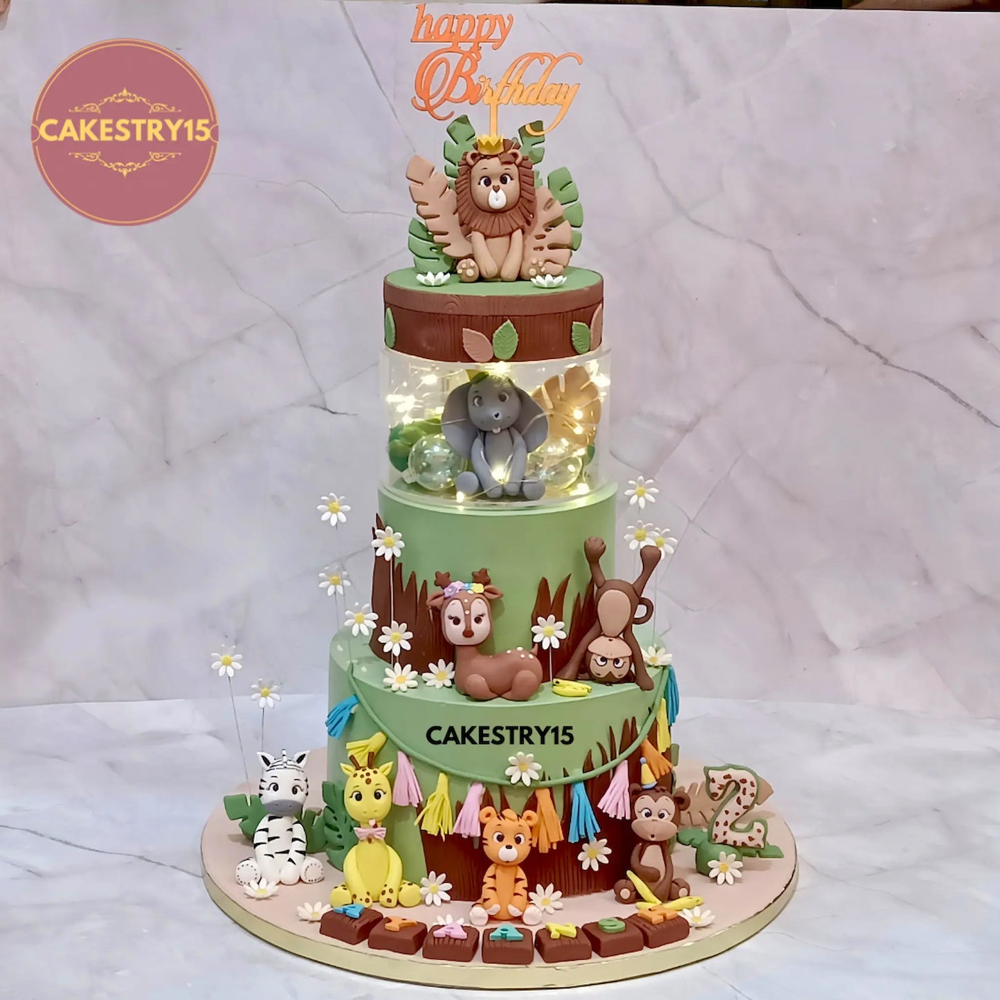 4kg jungle theme choco chips birthday cake with fondant lion, elephant, zebra, giraffe, tiger, monkey, and deer from Cakestry15 Noida