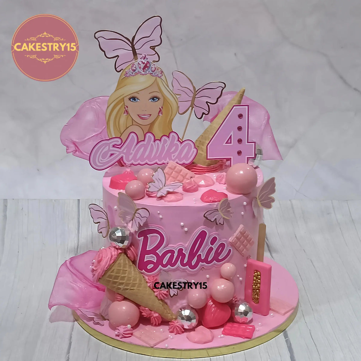 Barbie kids birthday cake with edible Barbie details from an eggless cakes bakery offering a theme cake Noida.
