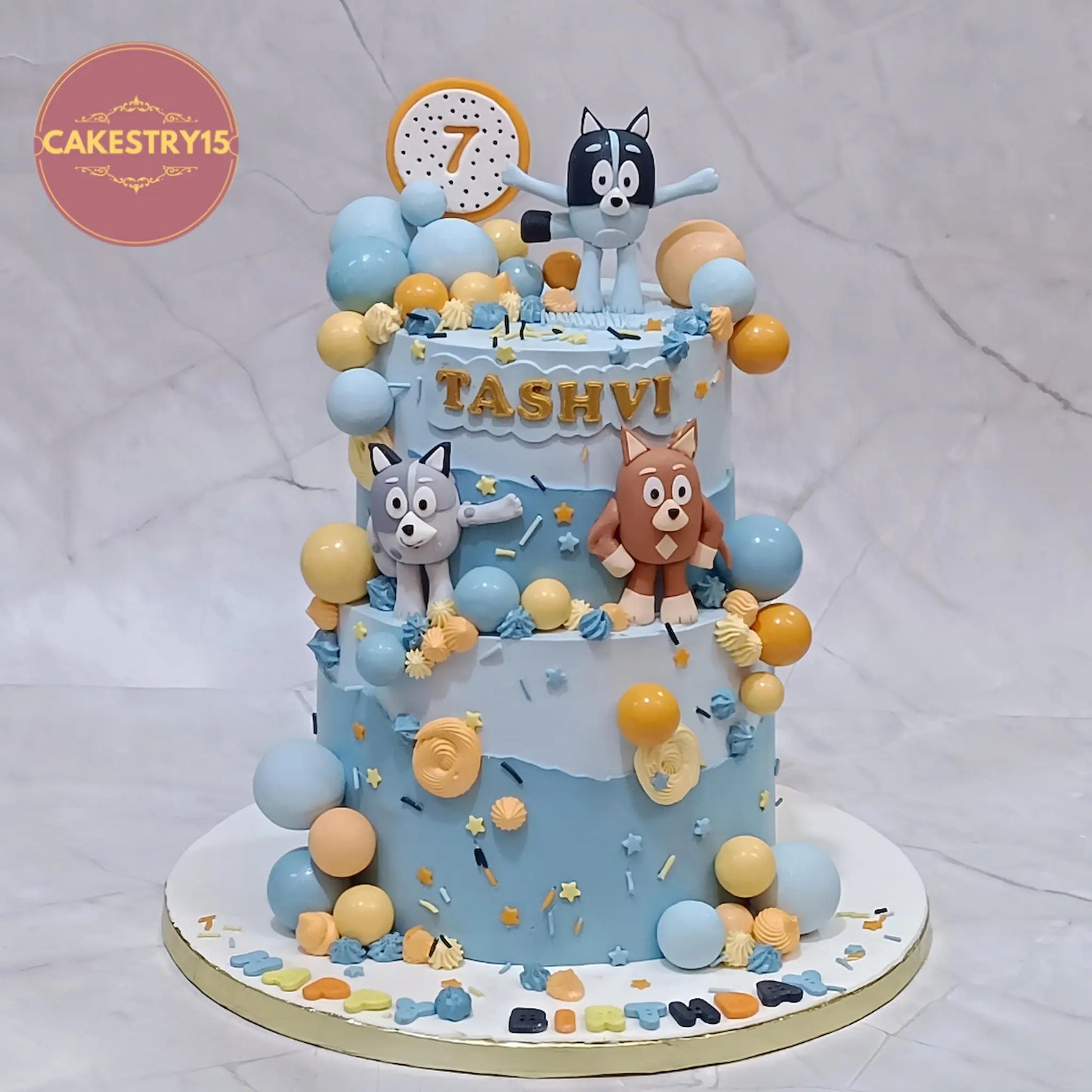 Bluey theme birthday cake in blue shades with dog toppers, eggless black forest kids birthday cake in Noida by cakestry15