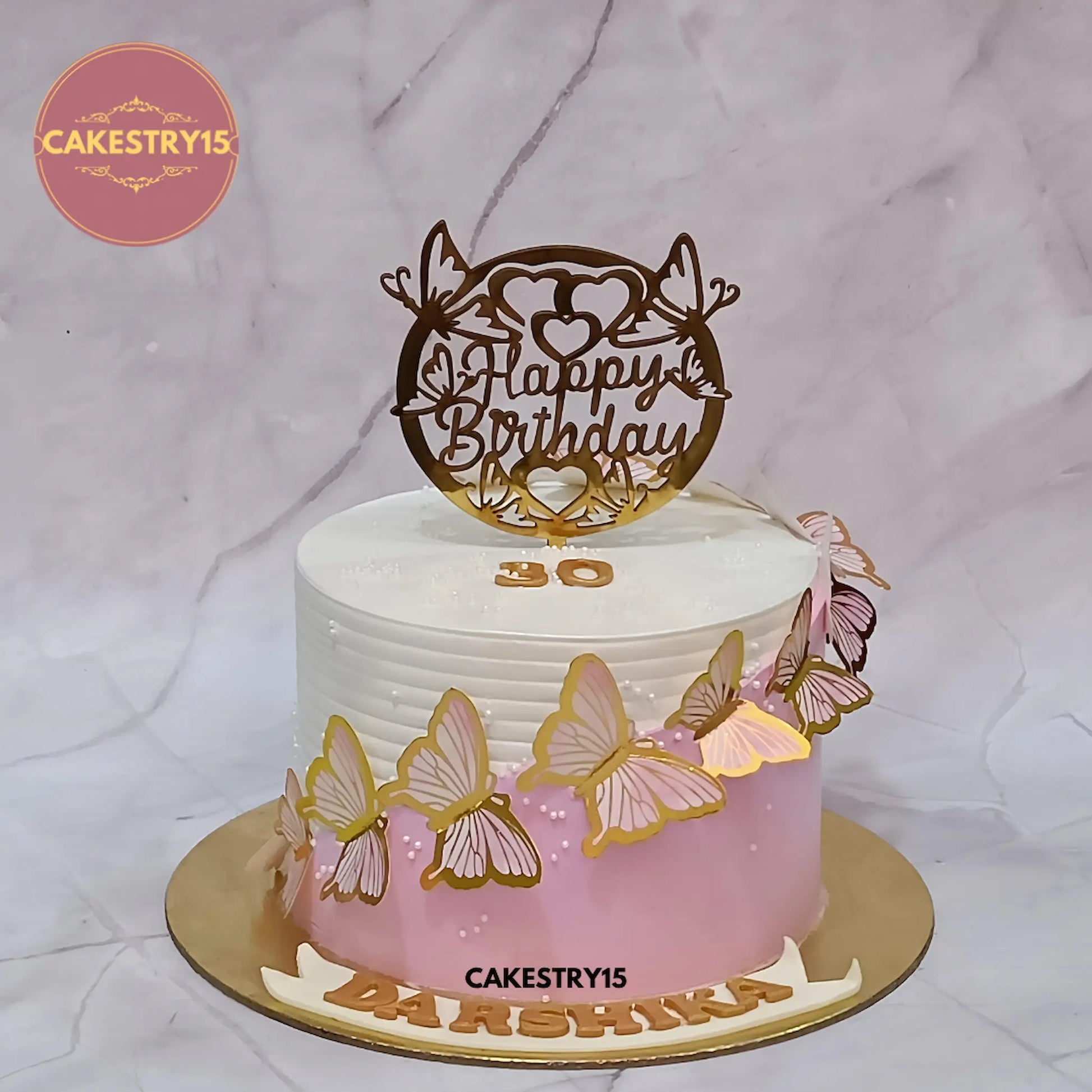 Elegant butterfly kids birthday cake with pink and ivory design, premium theme cake Noida style made with eggless cakes craftsmanship.