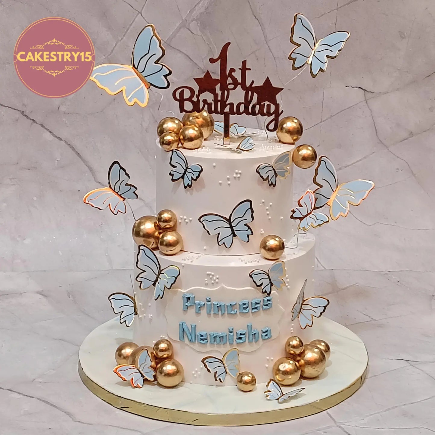 Butterfly theme kids birthday cake with faux golden balls and faux butterflies, premium eggless cakes and theme cake Noida design.