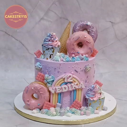 Candyland kids birthday cake with donuts, rainbow and candy elements, premium eggless cakes and theme cake Noida.
