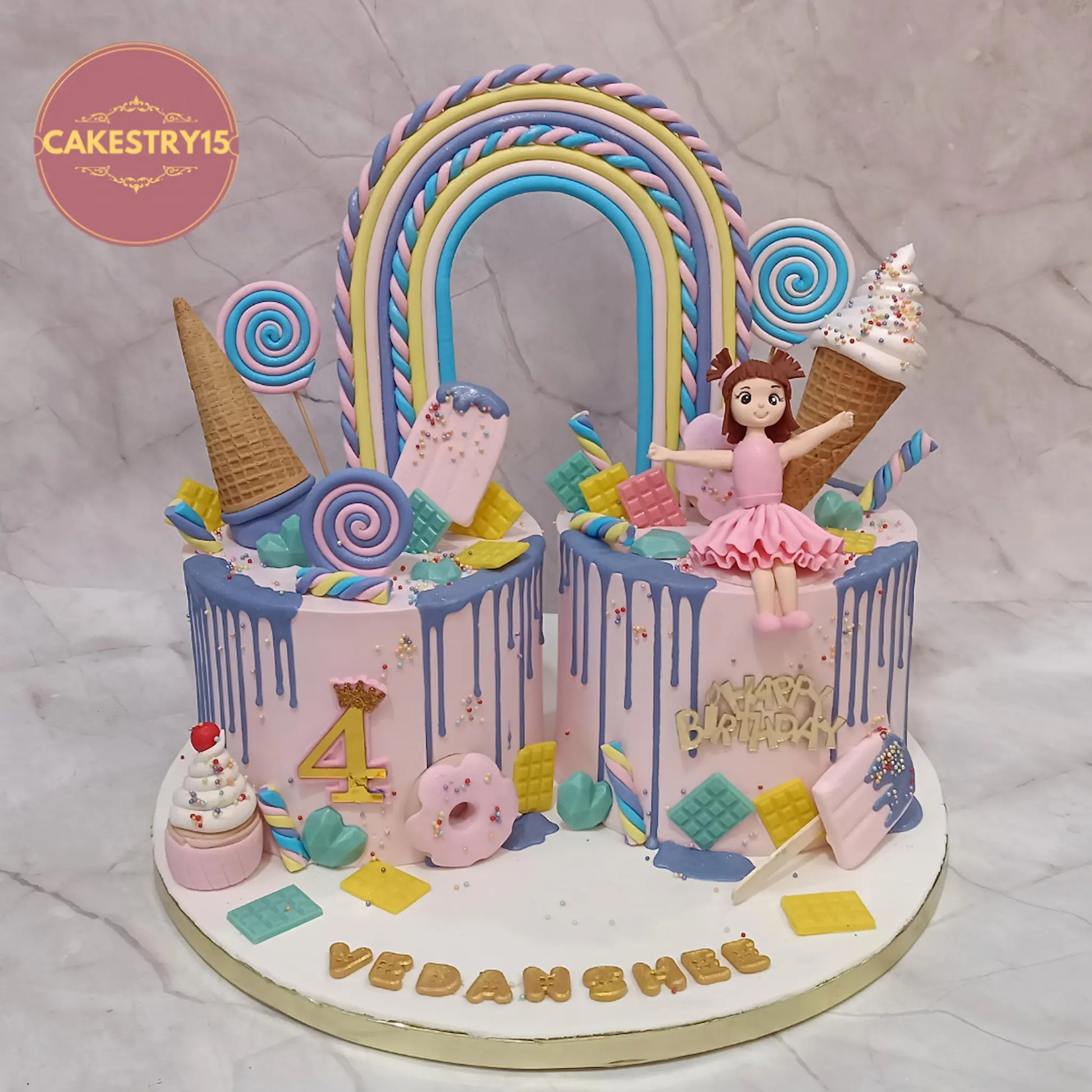Candyland theme 4th birthday cake for girl with rainbow, candies and figurine, 4kg eggless chocolate cake in Noida by cakestry15