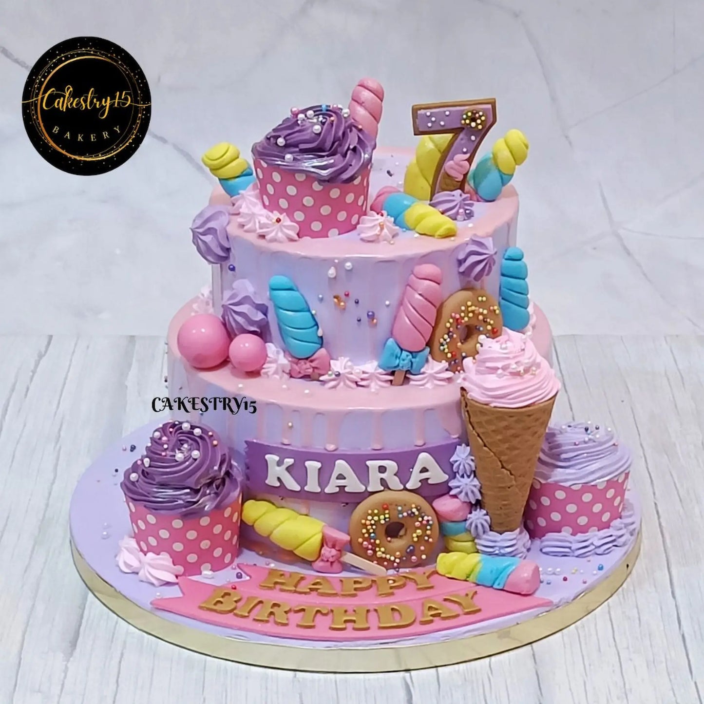 Candyland kids birthday cake theme cake Noida with colorful fondant design in eggless cakes 