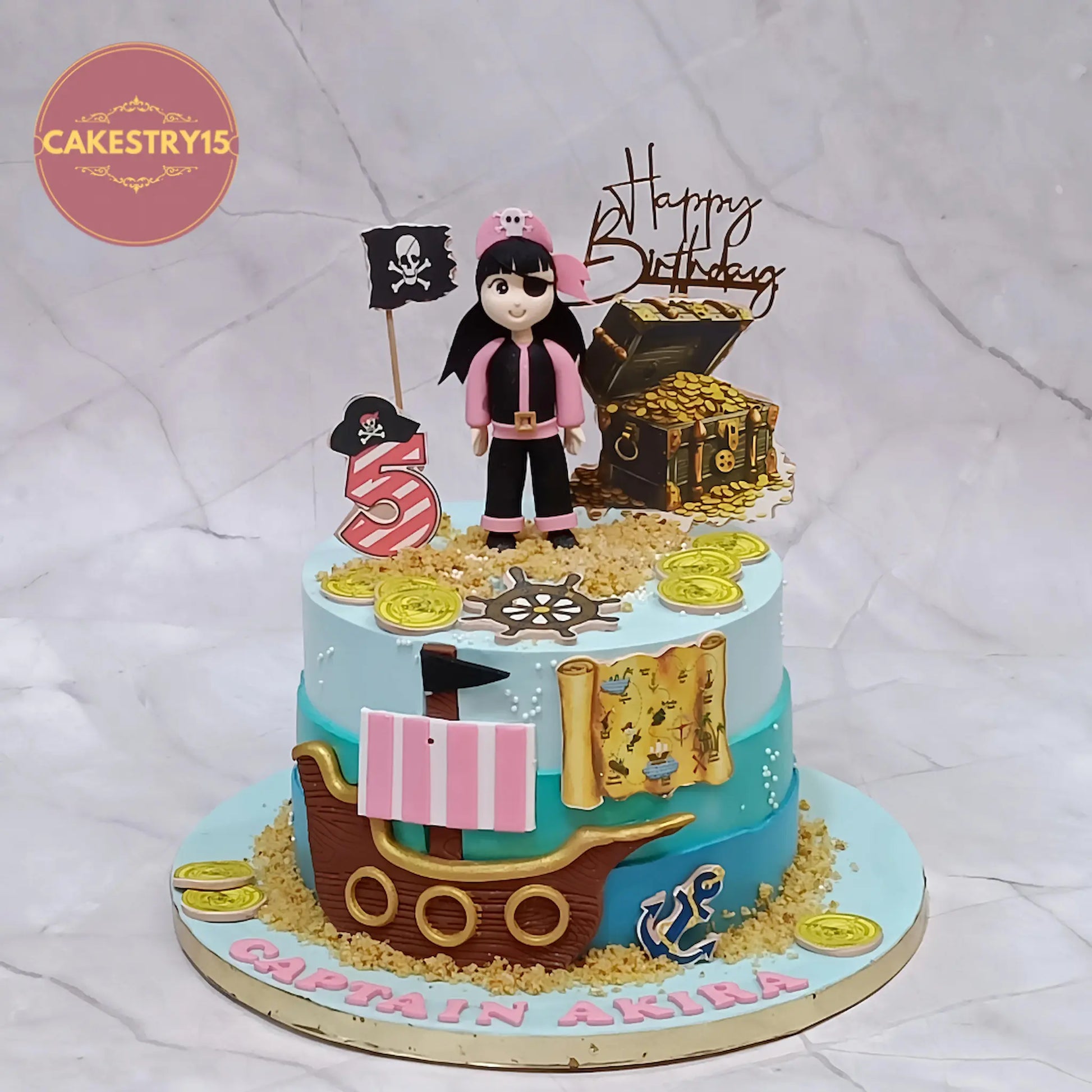 Eggless pirate theme birthday cake for kids with captain Akira name, pirate ship and treasure design in Noida by cakestry15