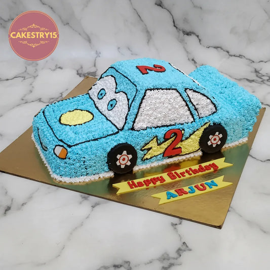 Car theme kids birthday cake with a detailed car-shaped design, available as an eggless theme cake in Noida.