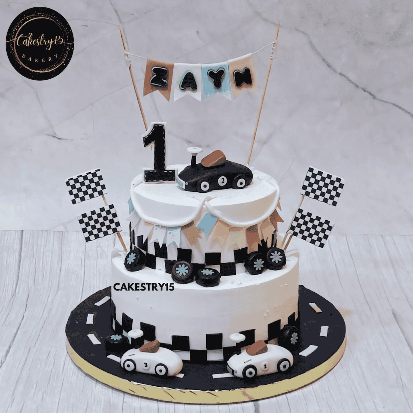 Eggless car theme first birthday cake for Zayn with racing cars and chocolate vanilla flavour by Cakestry15 Noida