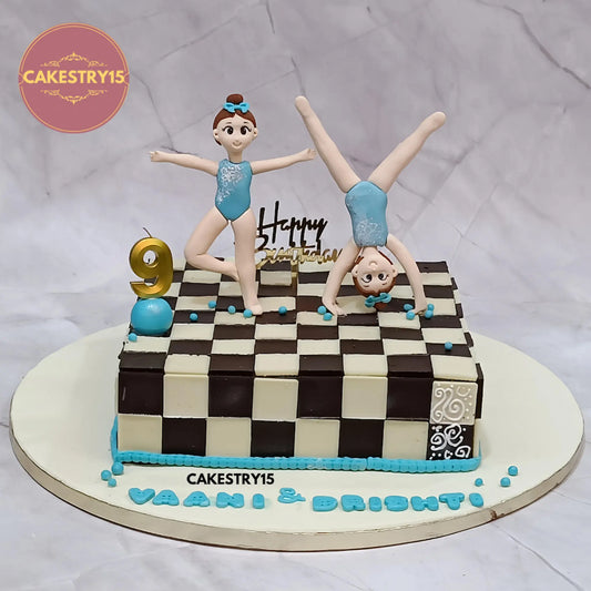 3kg chocolate chess-themed twins birthday cake with girl figurines, age 9 candle, made by Cakestry15 in Noida