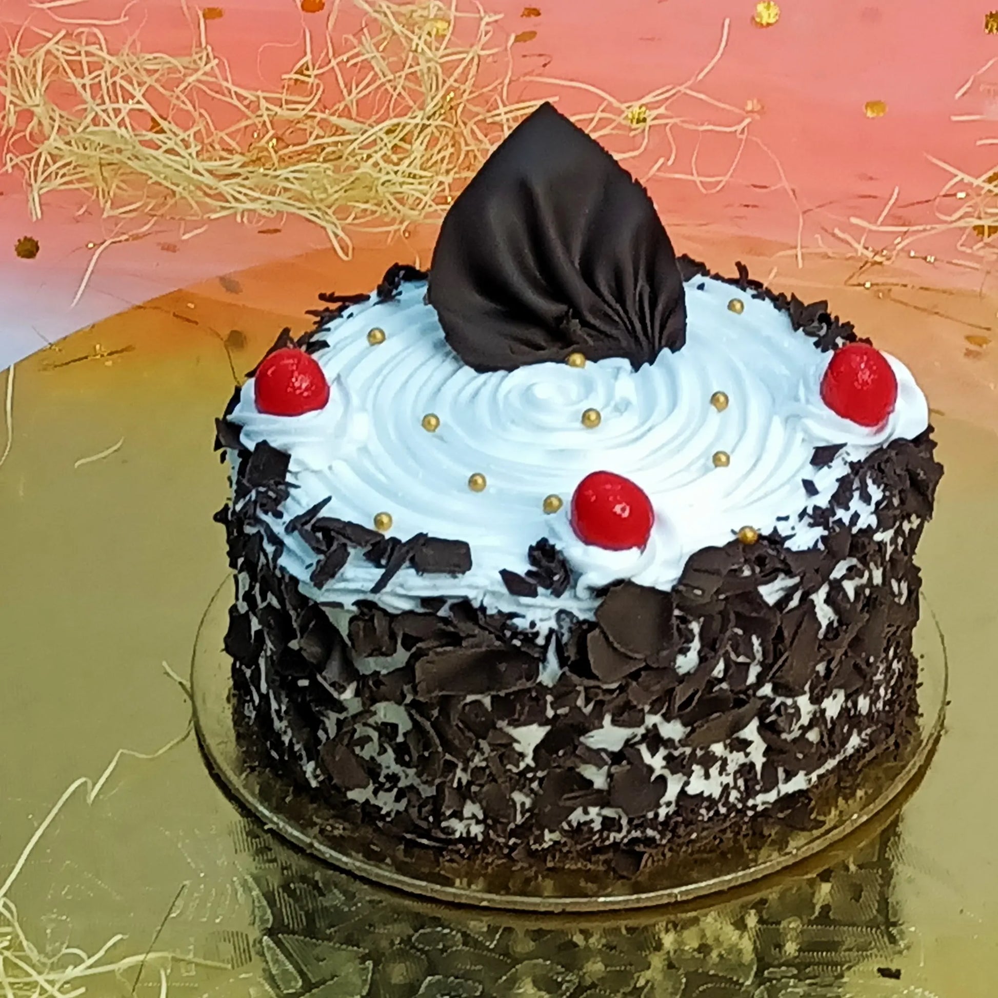 1kg black forest eggless cake with whipped cream, cherries, and chocolate shavings