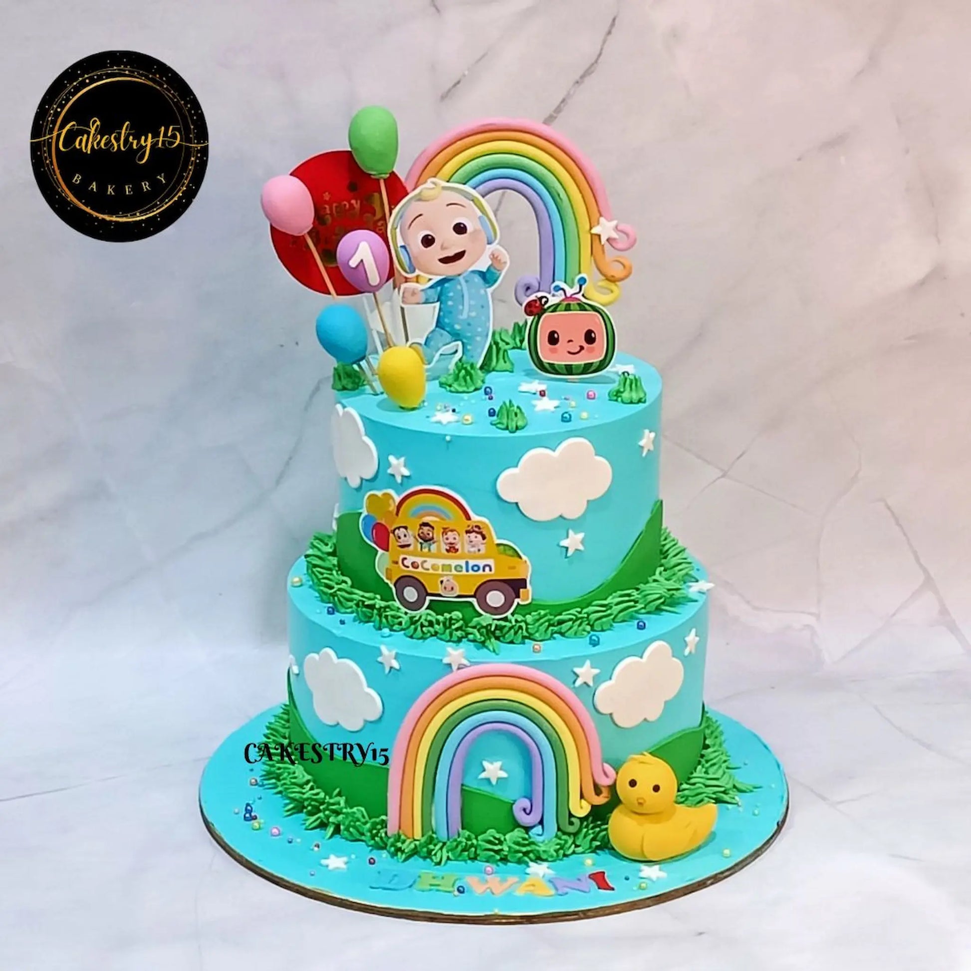 Eggless Cocomelon Blue first birthday cake for kids with rainbow and balloon design in Noida by Cakestry15