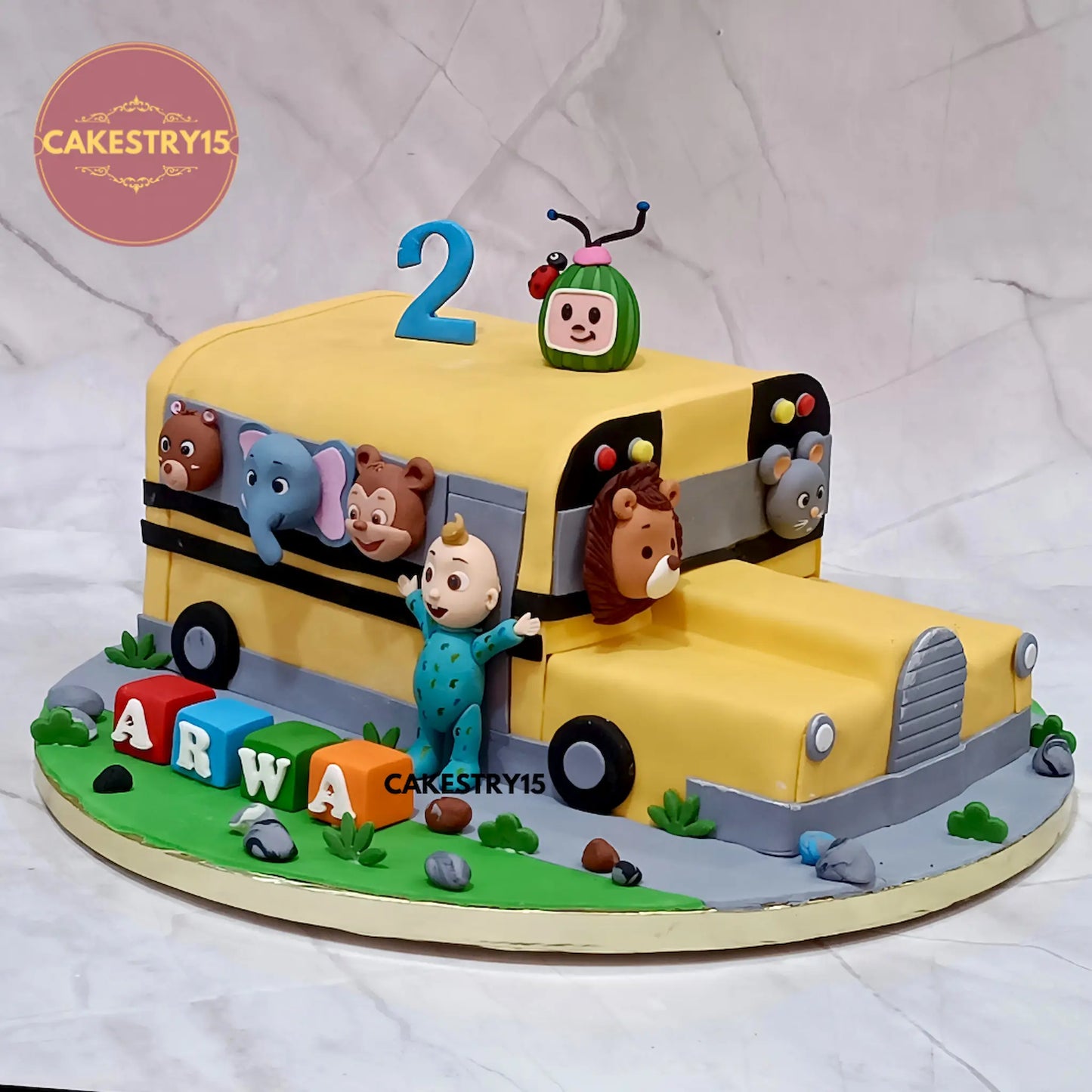 Eggless Cocomelon bus theme kids birthday cake in Noida with fondant characters and chocolate flavour custom design