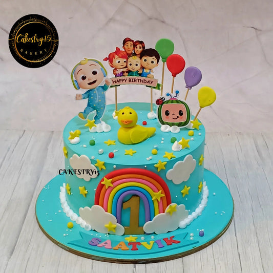 Eggless cocomelon ducky first birthday cake with rainbow and balloons for kids in Noida by Cakestry15