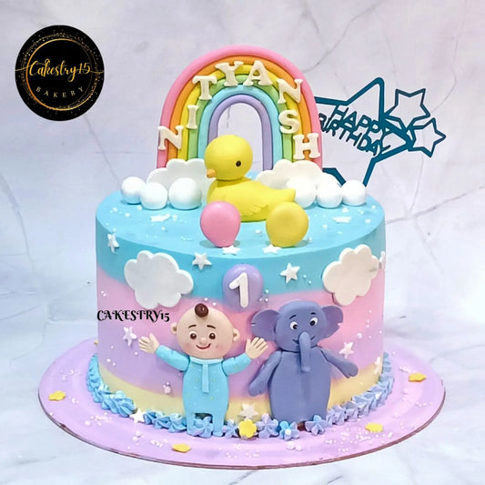 Eggless Cocomelon and elephant first birthday cake with rainbow, duck and fondant decorations for kids birthday in Noida
