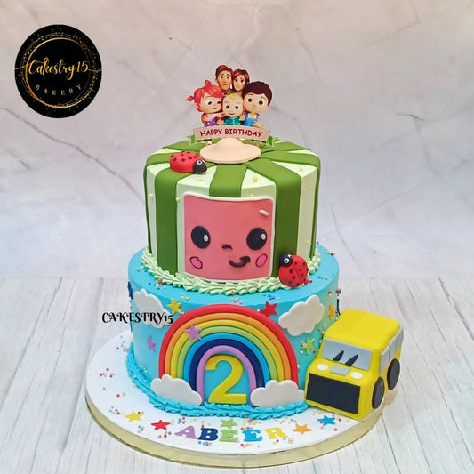 Eggless cocomelon family party kids birthday cake in Noida with rainbow bus fondant design chocolate flavour custom cake for kids